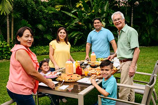 Multi-generational family enjoying an outdoor BBQ together
